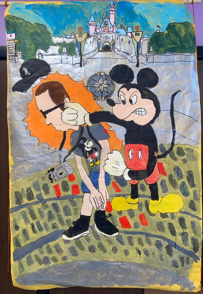 A painting of Mickey Mouse angrily punches a tourist, causing his ball cap to fly off. The tourist, wearing a Mickey Mouse T-shirt and carrying a camera, stands in front of the Disneyland Castle.