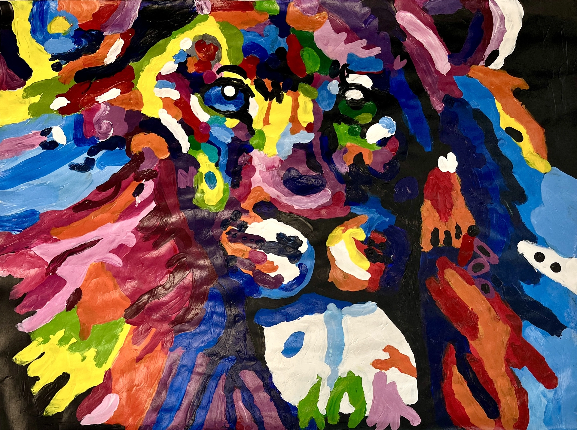 An abstract rendition of a male lion's head in two-tone green and blue eyes that stare at the viewer. Its fur and features are rendered in thick layers of bright, varied colors.