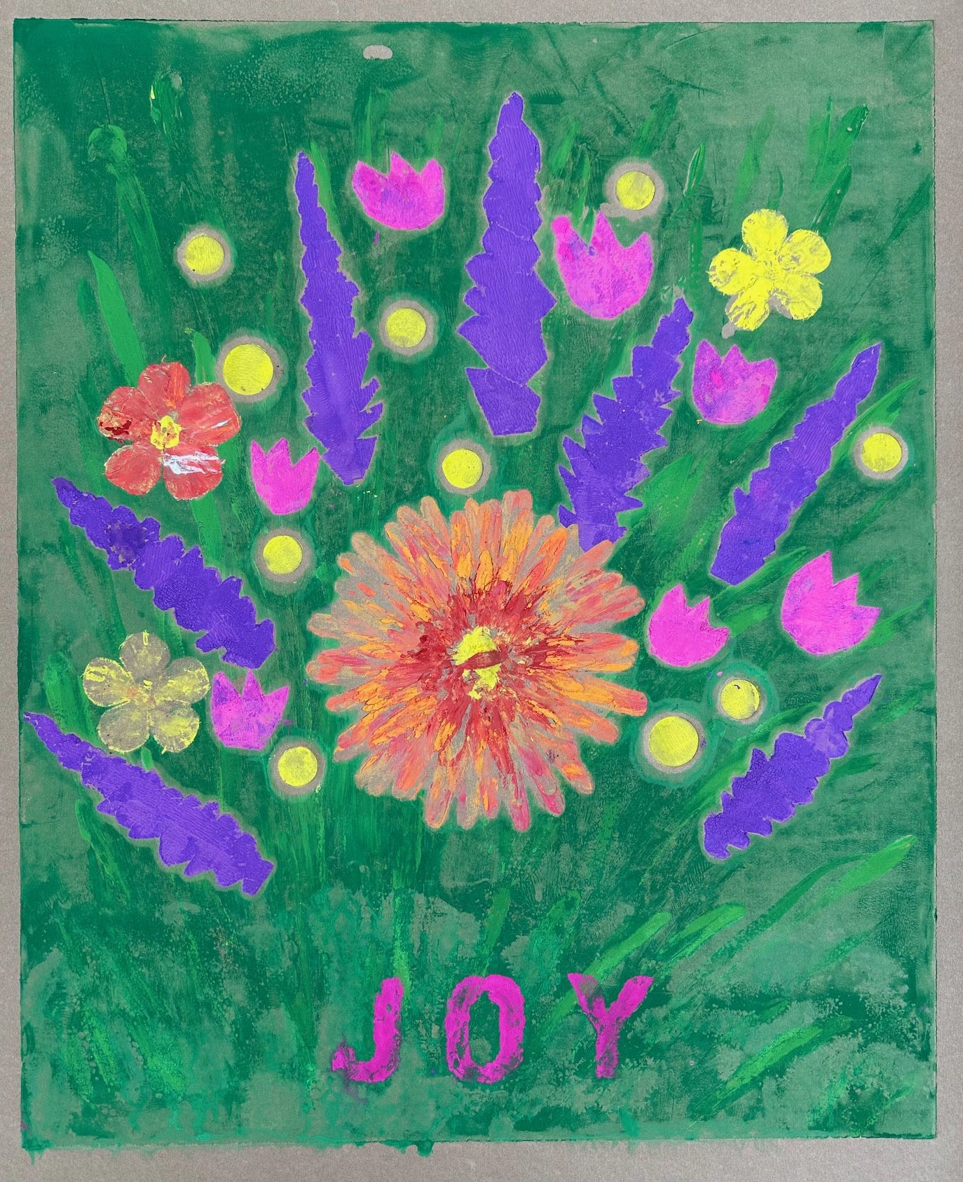 A bright grassy green colored background has a large orange and red flower centered on its page. Surrounding the flower are long purple lilac, yellow dots, smaller orange and yellow flowers, all ringed with small hot pink tulips. The word “JOY” is bold bright pink below the flowers.